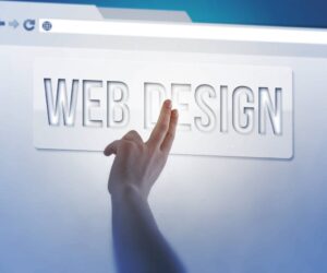A hand is touching a text label that reads "WEB DESIGN" on a translucent interface screen, suggesting interaction with a digital or virtual design tool.
