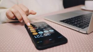 Freelancer with calculator and laptop