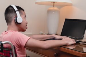 young person with special needs working on his laptop