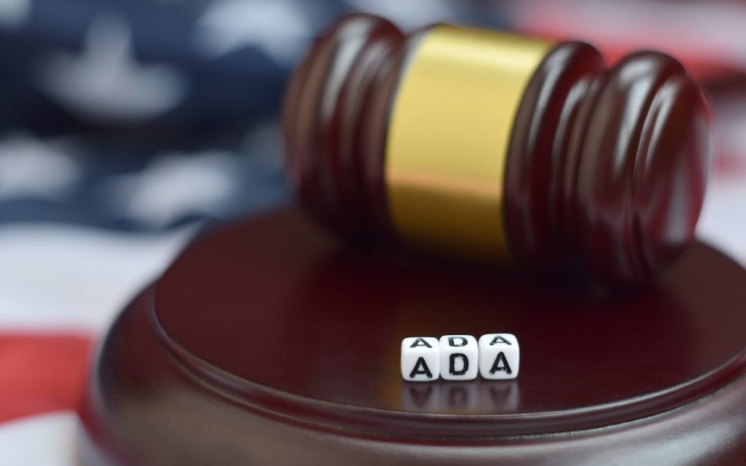 An American flag with a judge's mallet and ada acronym on top