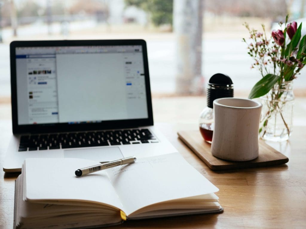 A writer's laptop and a notebook to write a long form article