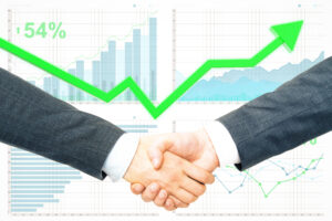 Two people in business suits shaking hands, highlighting a strong connection, with financial graphs and a green upward arrow indicating 54% growth in the background.